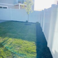 Beautiful white fence around a backyard